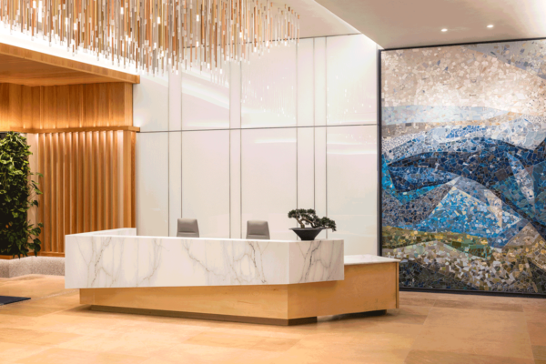 Real estate public art - a tile mosaic hangs behind the reception desk of 1121 at Symphony Square in Austin, Tx