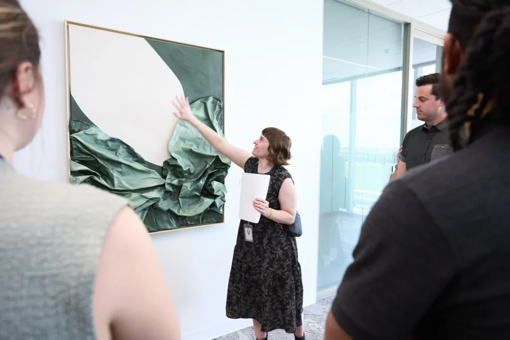 14-TIAA-art-package-portfolio Art consultant leads office art tour.