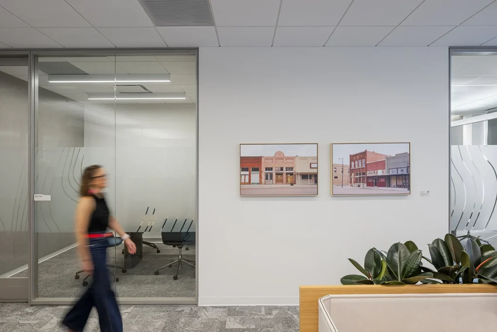 15-TIAA-Art-Package-Portfolio-2 Woman walking by art in office.