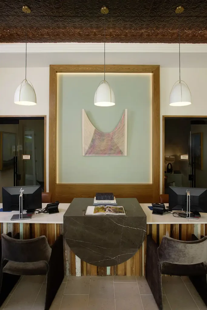 Framed textile art hangs in the office at multifamily development in McKinney, Texas. Art consulting by Art + Artisans.