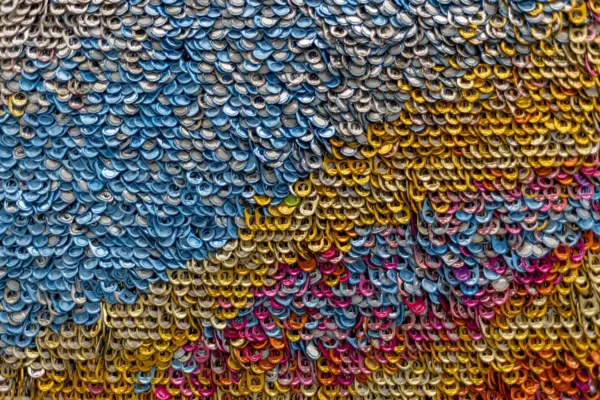 Detail of TIAA corporate art piece made of soda can tabs.