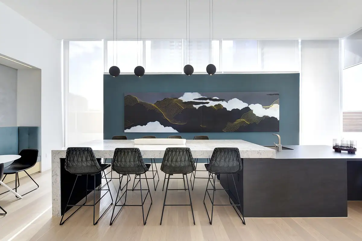 abstract landscape painting hangs in an apartment breakroom