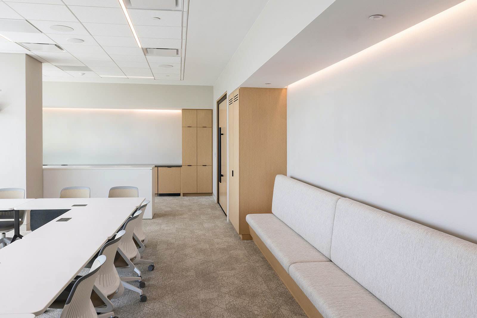 A beige and cream conference room with no art on the walls.