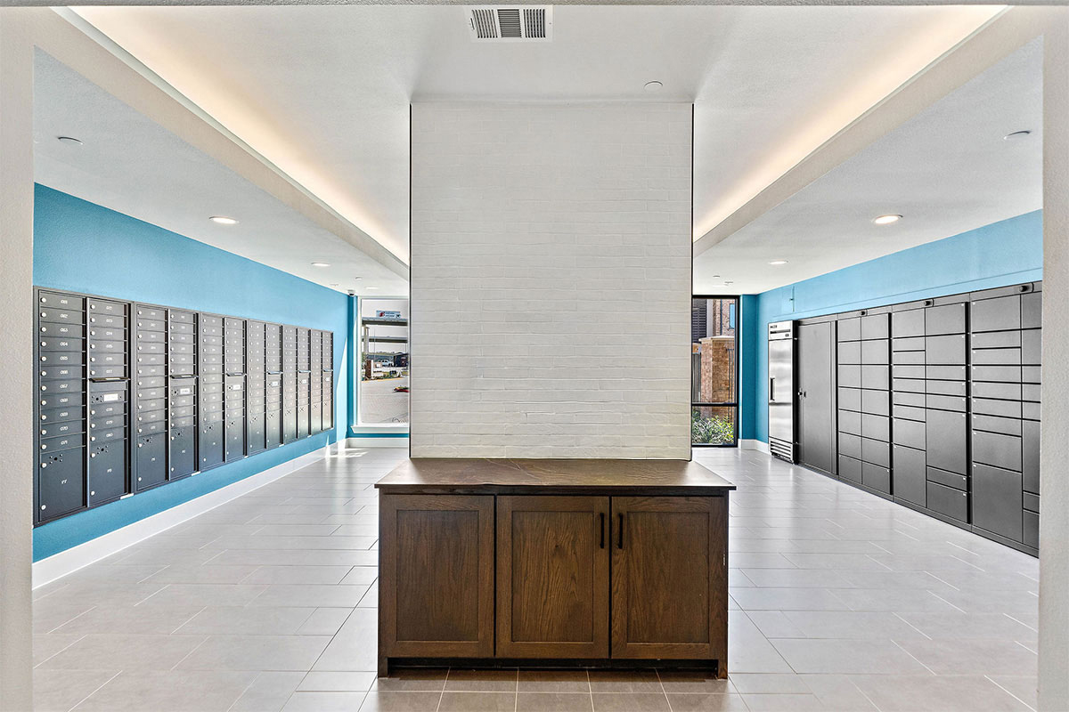 A large mail room with plain walls in a multifamily residential building.