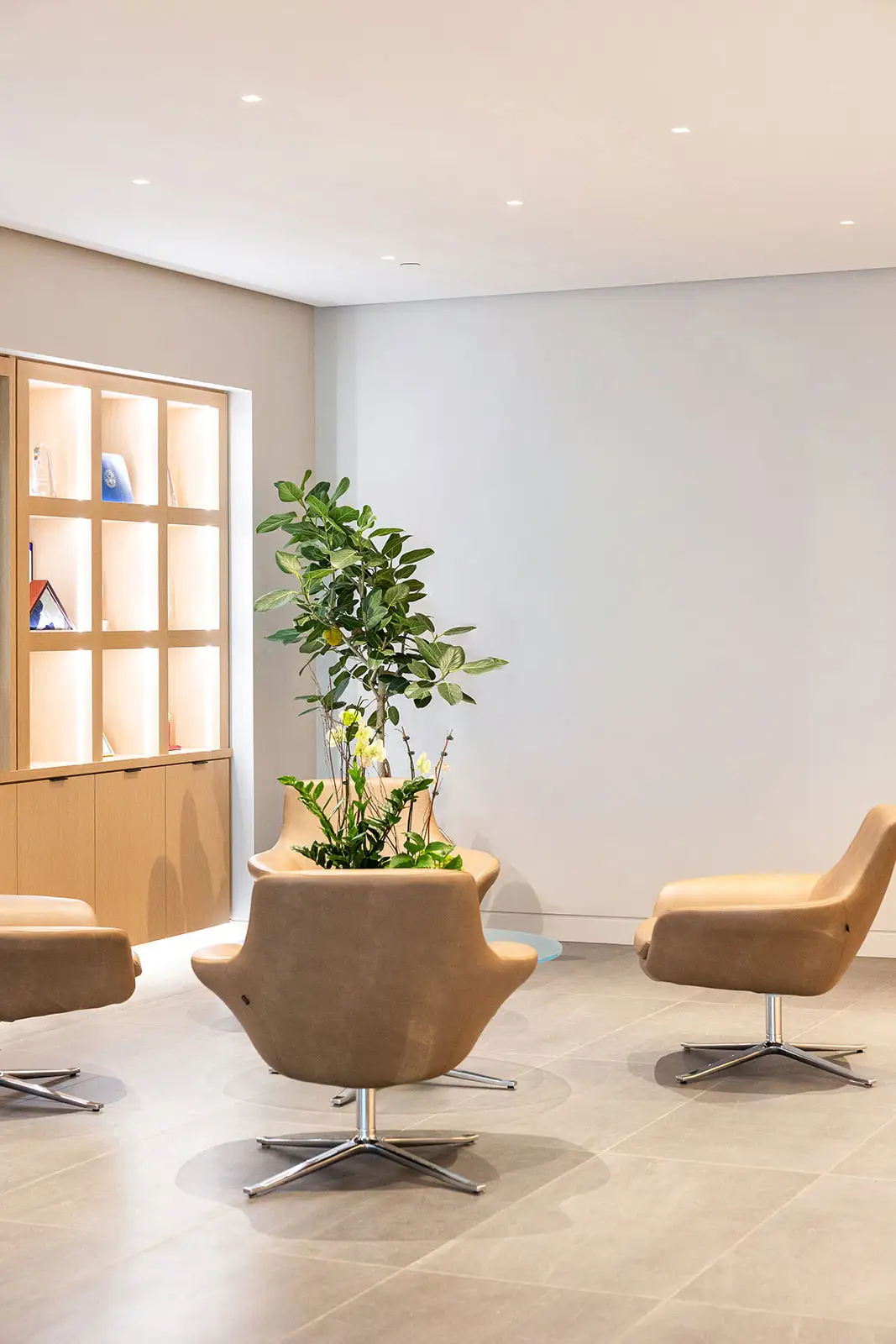 A beige and brown office lobby waiting area with no art on the wall.